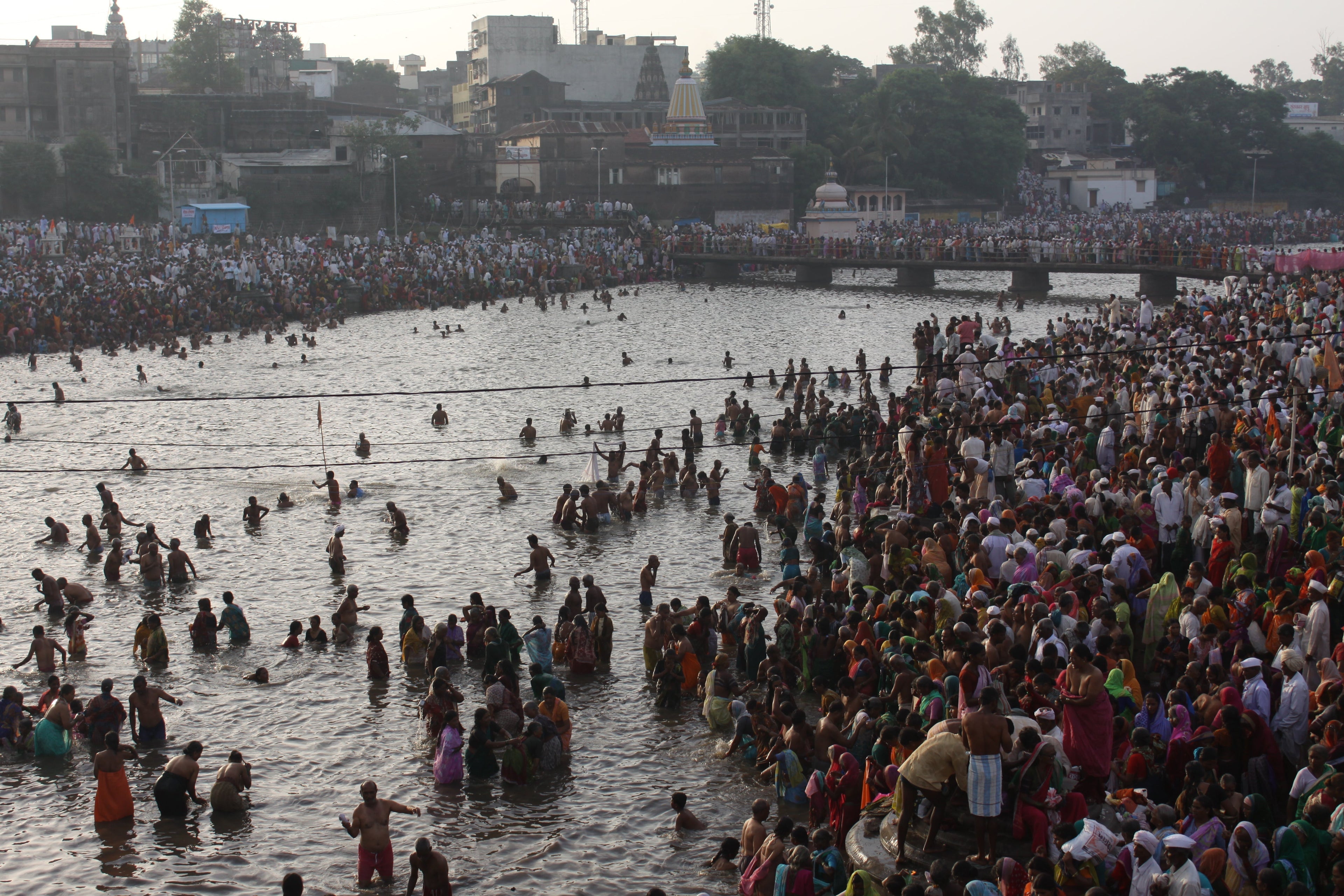 Millions of Warkaris bathing in the Bhima river at Pandharpur during Ashadhi Ekadashi Wari — photographed by Vinod Gupta, 2011