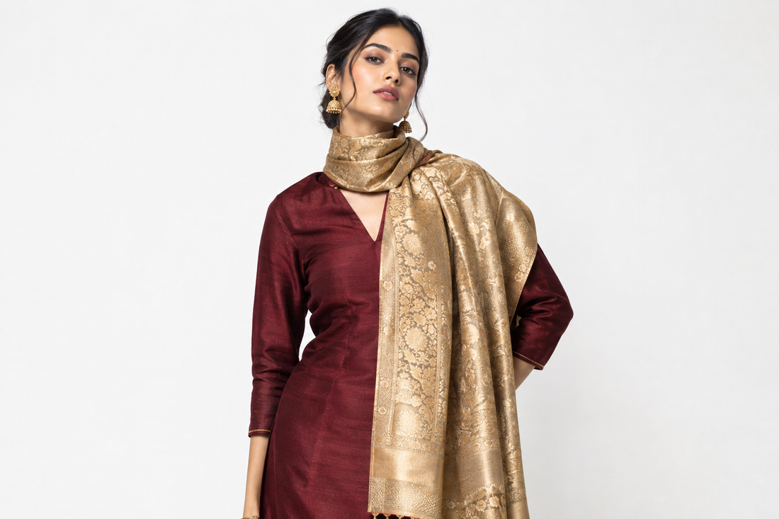Confident Indian woman in burgundy kurta styling gold designer stole in contemporary neck wrap